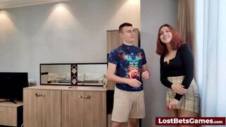 Redhead is sucking his hard cock after losing a game of strip darts - porn video